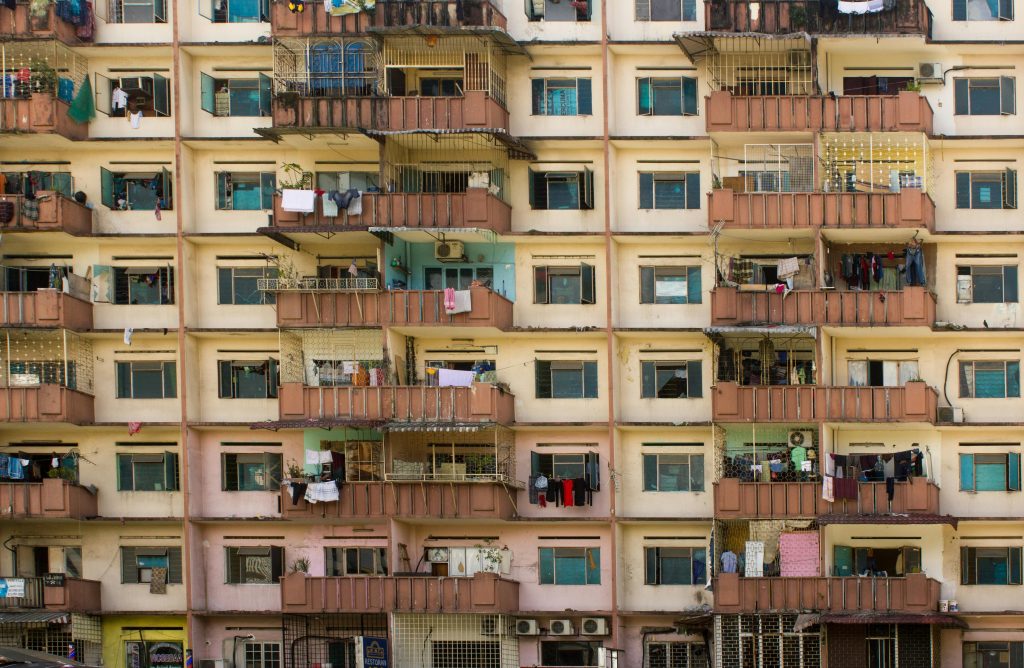 Detailed view of a residential apartment building facade in Kuala Lumpur, showcasing balconies and windows.